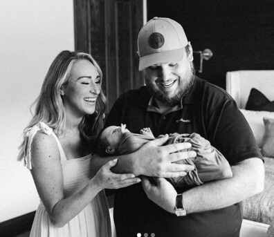 Chester Combs's son Luke Combs with his wife Nicole Hockings and their baby boy.